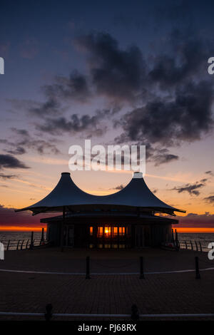 Aberystwyth Wales UK,  Tuesday 04 September 2018  UK Weather: Sunset shining through the windows of  Aberystwyth's distinctive    modern bandstand on the seafront promenade.  photo © Keith Morris / Alamy Live News Stock Photo