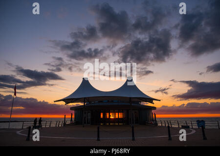 Aberystwyth Wales UK,  Tuesday 04 September 2018  UK Weather: Sunset shining through the windows of  Aberystwyth's distinctive    modern bandstand on the seafront promenade.  photo © Keith Morris / Alamy Live News Stock Photo