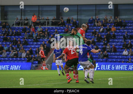 Oldham, UK. 4th September 2018, Boundary Park, Oldham, England: EFL Checkatrade Trophy, Oldham v Barnsley; Zeus de la Paz (13) of Oldham punches the ball away as Lloyd Isgrove (11) of Barnsley misses the header    EDITORIAL USE ONLY No use with unauthorised audio, video, data, fixture lists, club/league logos or 'live' services. Online in-match use limited to 45 images, no video emulation. No use in betting, games or single club/league/player publications and all English Football League images are subject to DataCo Licence Credit: News Images /Alamy Live News Stock Photo
