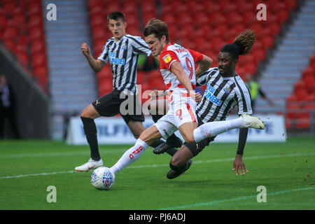 Doncaster, UK. 4th September 2018, Keepmoat Stadium, Doncaster, England: EFL Checkatrade Trophy, Doncaster v Newcastle U21 ;  John Marquis of Doncaster Rovers shoots at goal, but blocked by Stefan O'Connor of Newcastle United U21's   EDITORIAL USE ONLY No use with unauthorised audio, video, data, fixture lists, club/league logos or 'live' services. Online in-match use limited to 45 images, no video emulation. No use in betting, games or single club/league/player publications and all English Football League images are subject to DataCo Licence Credit: News Images /Alamy Live News Stock Photo