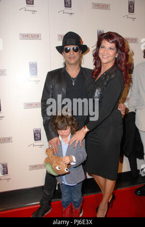 LAS VEGAS - MARCH 14: Guitarist Slash, his wife Perla Ferrar and their son Cash arrive at the grand opening of comic ventriloquist and impressionist Terry Fators show, 'Terry Fator & His Cast of Thousands,' at The Mirage Hotel & Casino on March 14, 2009 in Las Vegas, Nevada.  People:  Slash, Perla Ferrar Stock Photo