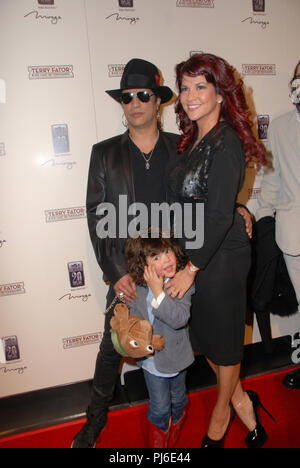 LAS VEGAS - MARCH 14: Guitarist Slash, his wife Perla Ferrar and their son Cash arrive at the grand opening of comic ventriloquist and impressionist Terry Fators show, 'Terry Fator & His Cast of Thousands,' at The Mirage Hotel & Casino on March 14, 2009 in Las Vegas, Nevada.  People:  Slash, Perla Ferrar Stock Photo