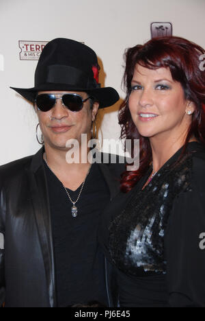 LAS VEGAS - MARCH 14: Guitarist Slash, his wife Perla Ferrar and their son Cash arrive at the grand opening of comic ventriloquist and impressionist Terry Fators show, 'Terry Fator & His Cast of Thousands,' at The Mirage Hotel & Casino on March 14, 2009 in Las Vegas, Nevada.  People:  Slash, Perla Ferrar Stock Photo