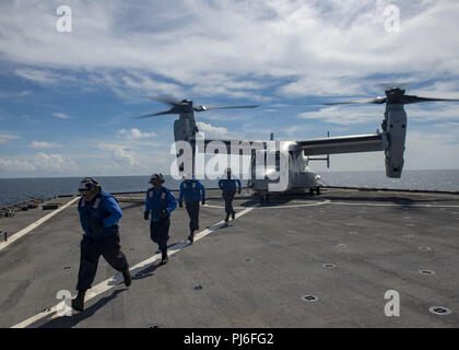 Atlantic Ocean. 3rd Sep, 2018. ATLANTIC OCEAN (Sept. 3, 2018) Sailors move away from an MV-22 Osprey after it lands on the flight deck of the amphibious dock landing ship USS Fort McHenry (LSD 43) during Carrier Strike Group (CSG 4) Amphibious Ready Group, Marine Expeditionary Unit exercise (ARGMEUEX). Kearsarge Amphibious Ready Group and 22nd Marine Expeditionary Unit are enhancing joint integration, lethality and collective capabilities of the Navy-Marine Corps team through joint planning and execution of challenging and realistic training scenarios. CSG-4 mentors, trains and assesses Stock Photo