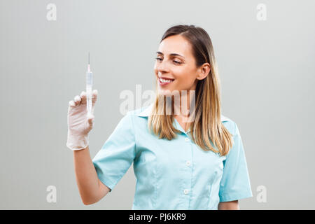 Portrait of nurse holding injection. Stock Photo