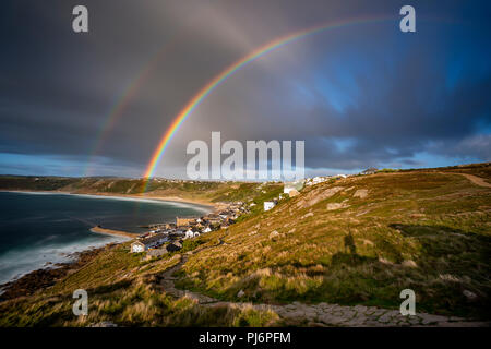 Huge double rainbow engulfs the beautiful Sennen Cove in Cornwall Stock Photo