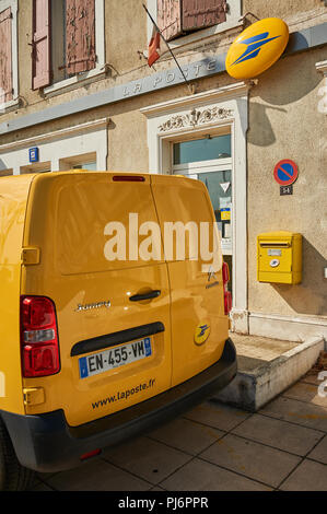 Yellow post office van outside a post office building, Ardeche region, France Stock Photo