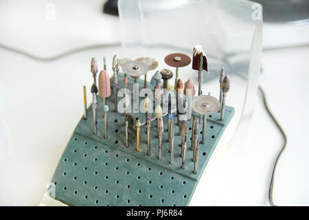 Different dental tools and burs. Dentures and dentistry. Dental prosthesis, dentures, prosthetics work. Dental technician in process of making denture Stock Photo