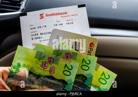 Canadian money fresh from an ATM machine in Sydney British Columbia using an American debit card. Stock Photo