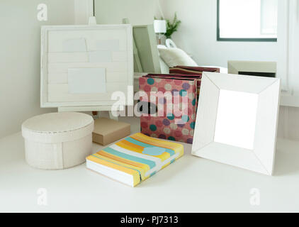 contemporary bedroom decoration with picture frame and book on a dresser Stock Photo