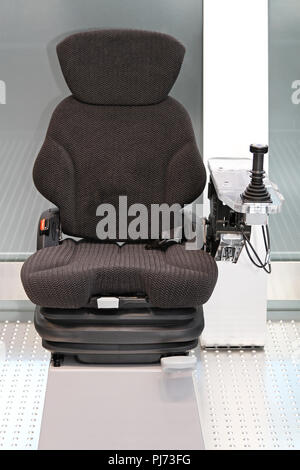 Ergonomic Seat with Joystick Controls for Construction Machinery Stock Photo