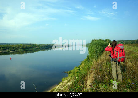 Backpacker with fotocamera near Oka river Stock Photo