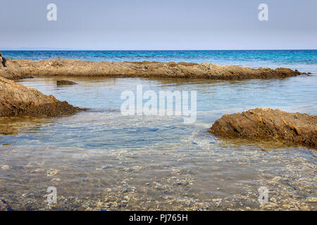 Calm translucent turquoise sea, beautiful rocky reef and underwater sea creatures Stock Photo