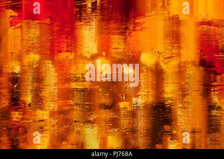 Shining, warm, yellow, amber, gold and orange abstract background texture. Appearance of lights reflected in wet surface. Painterly effect. Stock Photo