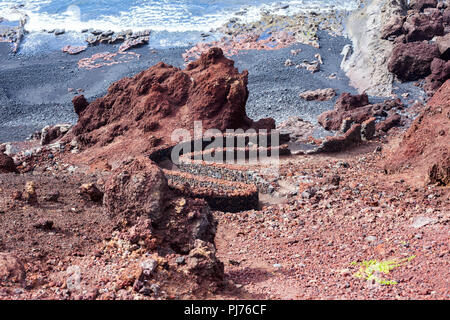 Stone formations and old wall in El Golfo, Lanzarote, Canary islands Stock Photo