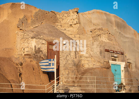 Traditional classic Greek Cave home on beach in Santorini Greece Stock Photo