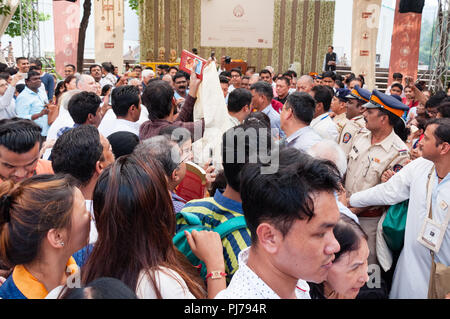 MUMBAI, INDIA – December 10 2017: Crowds jostling to see and photograph the Dalai Lama while policemen look on, as His Holiness the 14th Dalai Lama (B Stock Photo