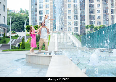 Nice joyful family having an evening walk Stock Photo