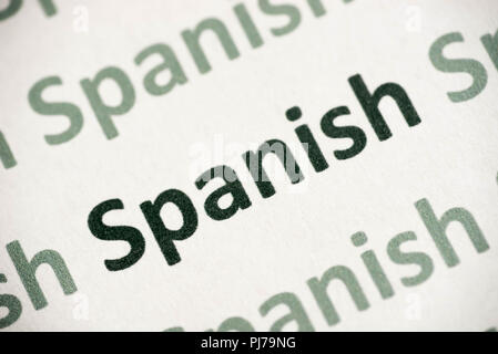 word Spanish language printed on white paper macro Stock Photo