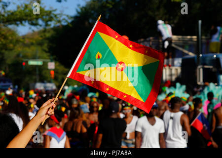 A person waves a flag of Grenada at the West Indian Day parade in Brooklyn Stock Photo
