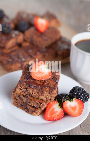 Healthy gluten free dairy dree paleo style  flourless  pumpkin brownies with chocolate chips, served with strawberries, selective focus Stock Photo
