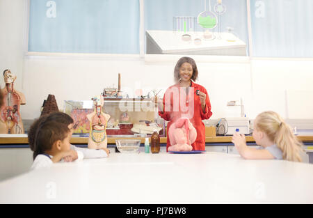 Science teacher and curious students with anatomical models Stock Photo