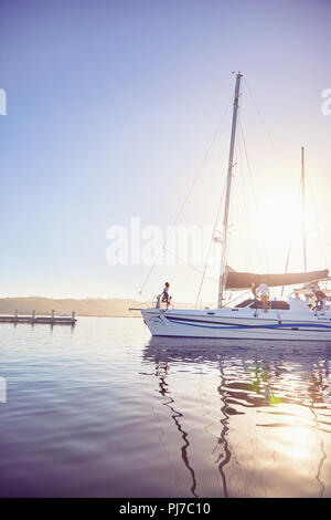 People on boat in sunny harbor Stock Photo