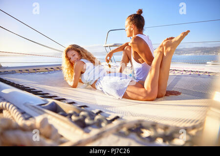 Portrait smiling woman relaxing on sunny catamaran Stock Photo