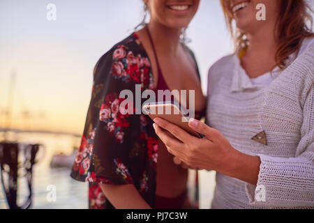Close up young women using smart phone Stock Photo
