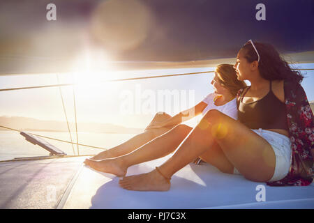 Young women relaxing on sunny boat Stock Photo