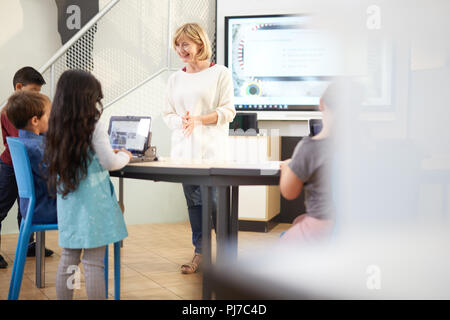 Teacher and students using laptops Stock Photo