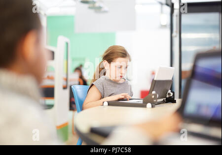 Focused girl using laptop Stock Photo