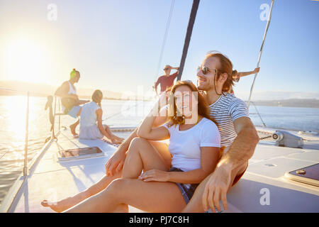 Couple relaxing on sunny boat Stock Photo