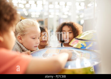 Curious kids at interactive exhibit in science center Stock Photo