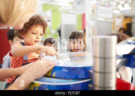 Curious kids at interactive exhibit in science center Stock Photo