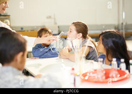 Kids smelling scents at interactive exhibit in science center Stock Photo