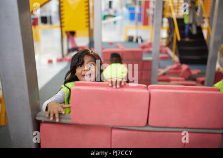 Portrait playful girl playing at construction exhibit in science center Stock Photo