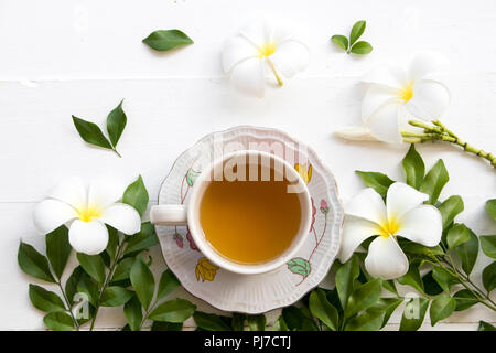 herbal health care hot mix honey lemon cough sore with flower frangipani on background white Stock Photo