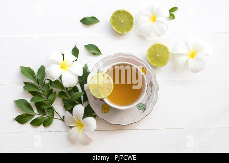 herbal health care hot mix honey lemon cough sore with flower frangipani on background white Stock Photo