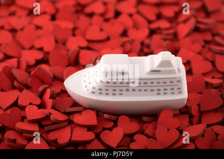 Ship toy on many red hearts Stock Photo