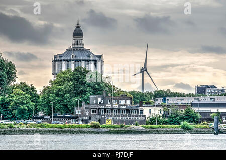 Rotterdam, The Netherlands, August 13, 2018: the old water tower at Kralingen De Esch, dating back to 1873, along with a modern wind turbine Stock Photo