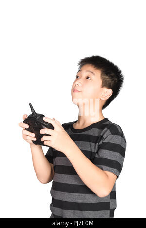 Asian boy holding hexacopter drone and radio remote control (controlling handset) for helicopter, drone or plane, studio shot isolated on white backgr Stock Photo