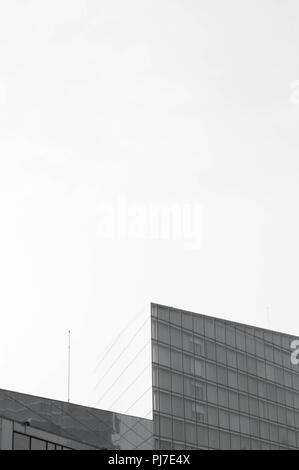 Stunning architectural dynamic shape building with blank space. Black and white Stock Photo