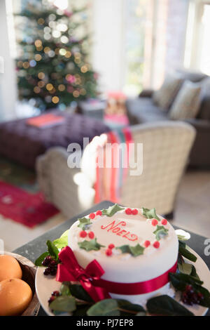 Decorated noel Christmas cake on sideboard in living room Stock Photo