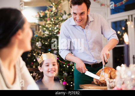Family carving Christmas turkey, enjoying dinner Stock Photo