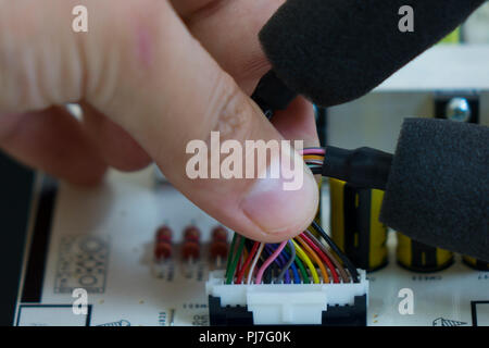 Quality control and assembly of SMT printed components on circuit board in QC lab of PCB manufacturing high-tech factory Stock Photo