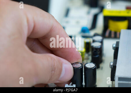 Close up of a man repairing electrical component of a computer. Stock Photo