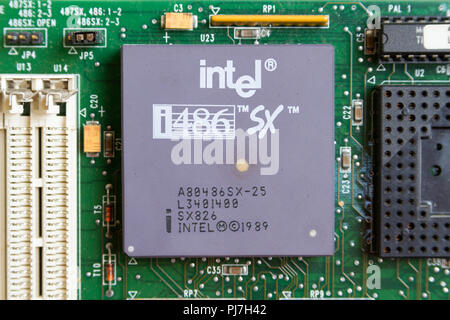 An Intel i486 SX (80486SX) processor (CPU) from 1989 in a socket on a motherboard. Caklov, Slovakia. 2018/7/28. Stock Photo