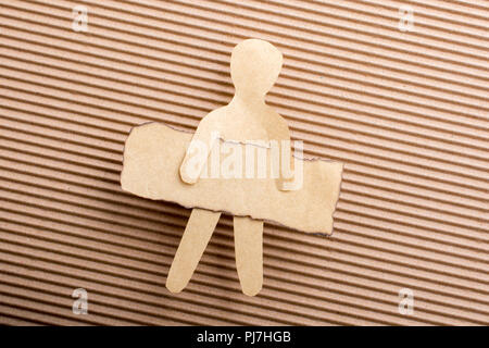 Paper man shape holding burnt note paper in hand Stock Photo