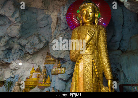 Burmese Buddha statue in buddhist cave temple in Mandalay Stock Photo